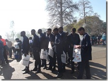 A "Gospel" group waiting to go-in; some reading Gospel tracts